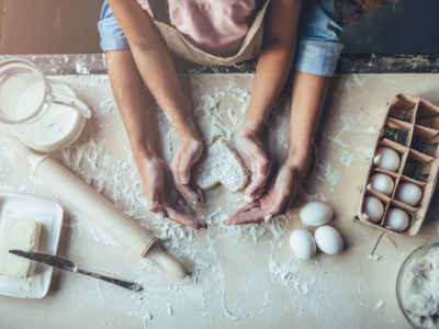 Mother and child work together in kitchen.