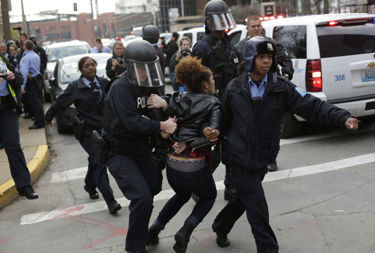 A woman is dragged away by cops during a Black Lives Matter protest