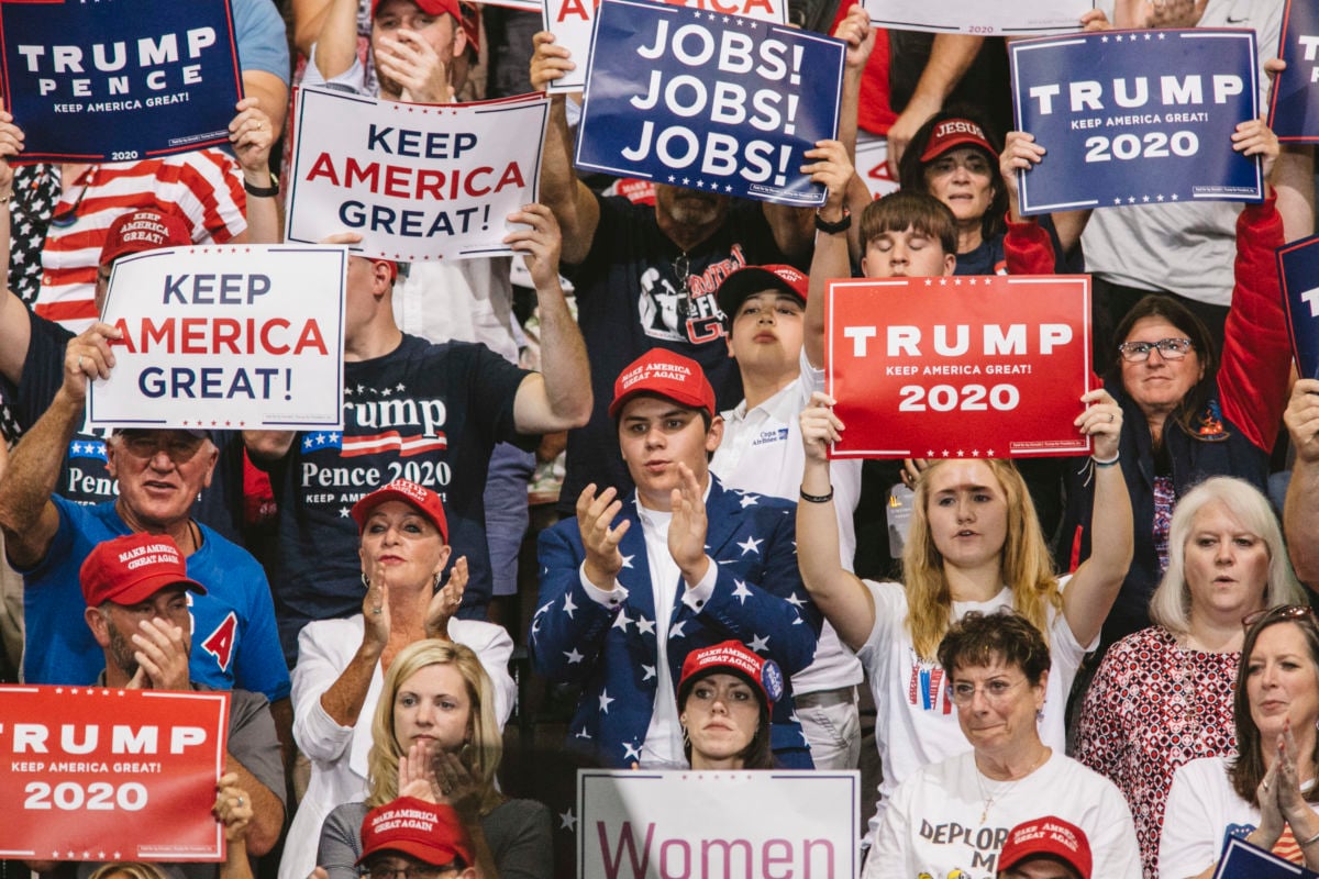 Trump supporters display signs and shout during a rally