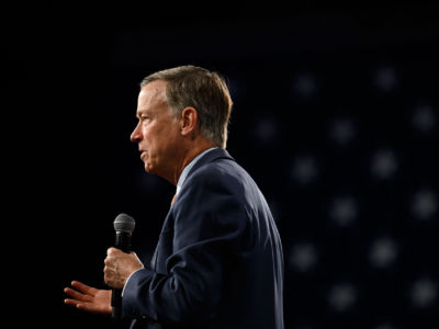 John Hickenlooper speaks into a microphone