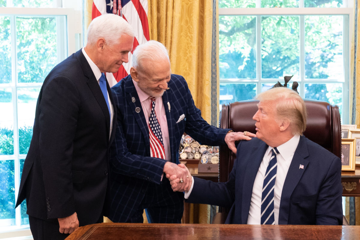 Former astronaut Buzz Aldrin shakes President Trump's hand as Vice President Pence watches.