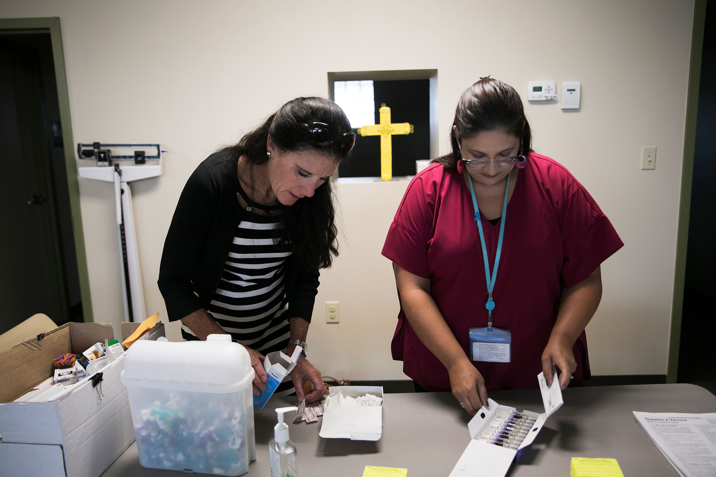 Summit County Public Health nurse Rachel Flossie (left) and communicable disease supervisor Tracy Rodriguez prepare to give vaccinations to clients during a South Street Ministries program in Akron, Ohio, last month. In the wake of the opioid crisis, the highly communicable hepatitis A virus is spreading in more than half the states, including Ohio. “It’s getting into the general public,” Rodriguez says. “It’s scary.”
