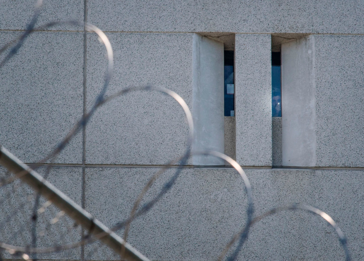 A prisoner shines a torch from the main ICE detention center in downtown Los Angeles, California, on July 14, 2019.