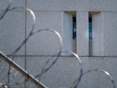 A prisoner shines a torch from the main ICE detention center in downtown Los Angeles, California, on July 14, 2019.