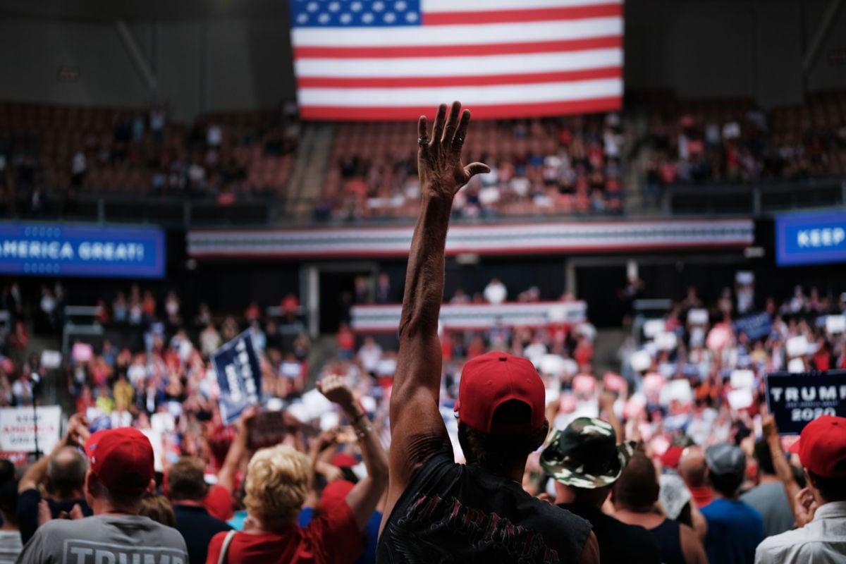 People react as President Trump speaks to supporters at a rally on August 15, 2019, in Manchester, New Hampshire.