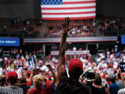 People react as President Trump speaks to supporters at a rally on August 15, 2019, in Manchester, New Hampshire.