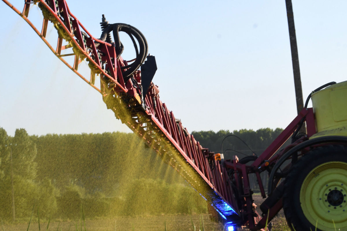 A farmer sprays Roundup 720 herbicide produced by agrochemical giant Monsanto on May 11, 2018, on a field of corn in Piace, northwestern France.