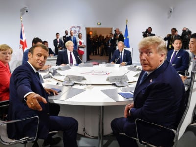 France's President Emmanuel Macron and President Trump pose for the media as they meet for the first working session of the G7 Summit on August 25, 2019, in Biarritz, France.
