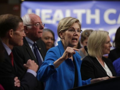 Sen. Elizabeth Warren speaks on health care as Sen. Bernie Sanders listens during an event September 13, 2017, on Capitol Hill in Washington, D.C.