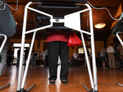 People use electronic voting machines to cast their ballot in Laguna Beach, California on election day November 6, 2018.