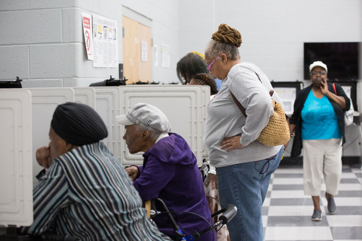 People line up at booths to vote