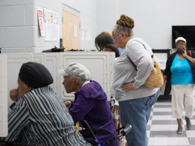 People line up at booths to vote