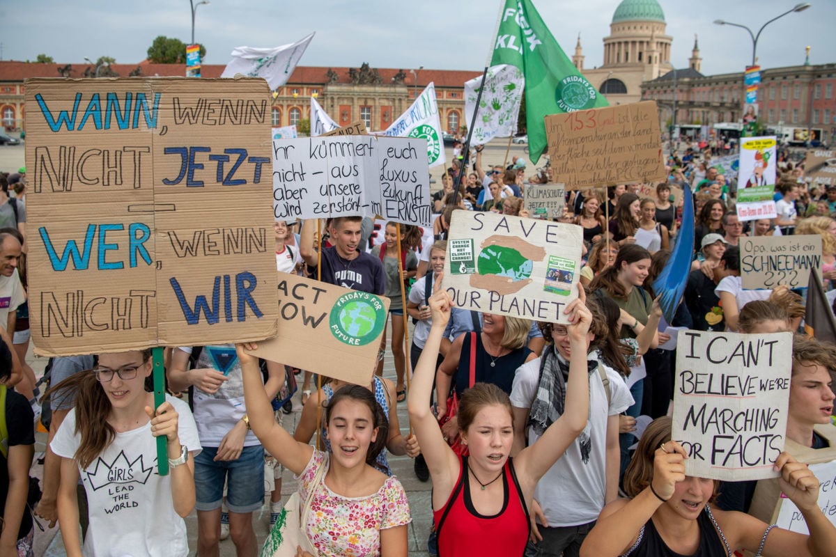 Supporter of the Fridays for Future movement hold placards during a protest for climate action on August 30, 2019, in Potsdam, eastern Germany.