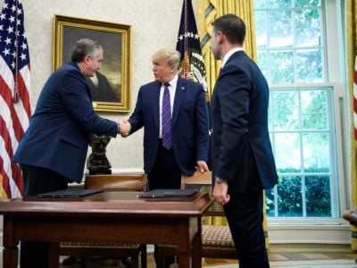 Donald Trump shakes Guatemala's Interior Minister Enrique Degenhart hand as acting U.S. Secretary of Homeland Security Kevin K. McAleenan watches after a safe-third agreement was signed, regarding people seeking asylum while passing through Guatemala, in the Oval Office of the White House on July 26, 2019, in Washington, D.C.