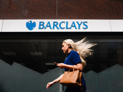 A woman walks past a branch of Barclays bank on Wormwood Street in London, England, on July 26, 2019.