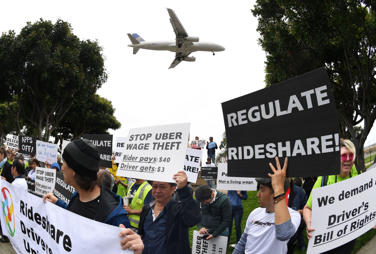 Rideshare drivers for Uber and Lyft stage a strike and protest at the LAX International Airport in Los Angeles, California, on May 8, 2019.