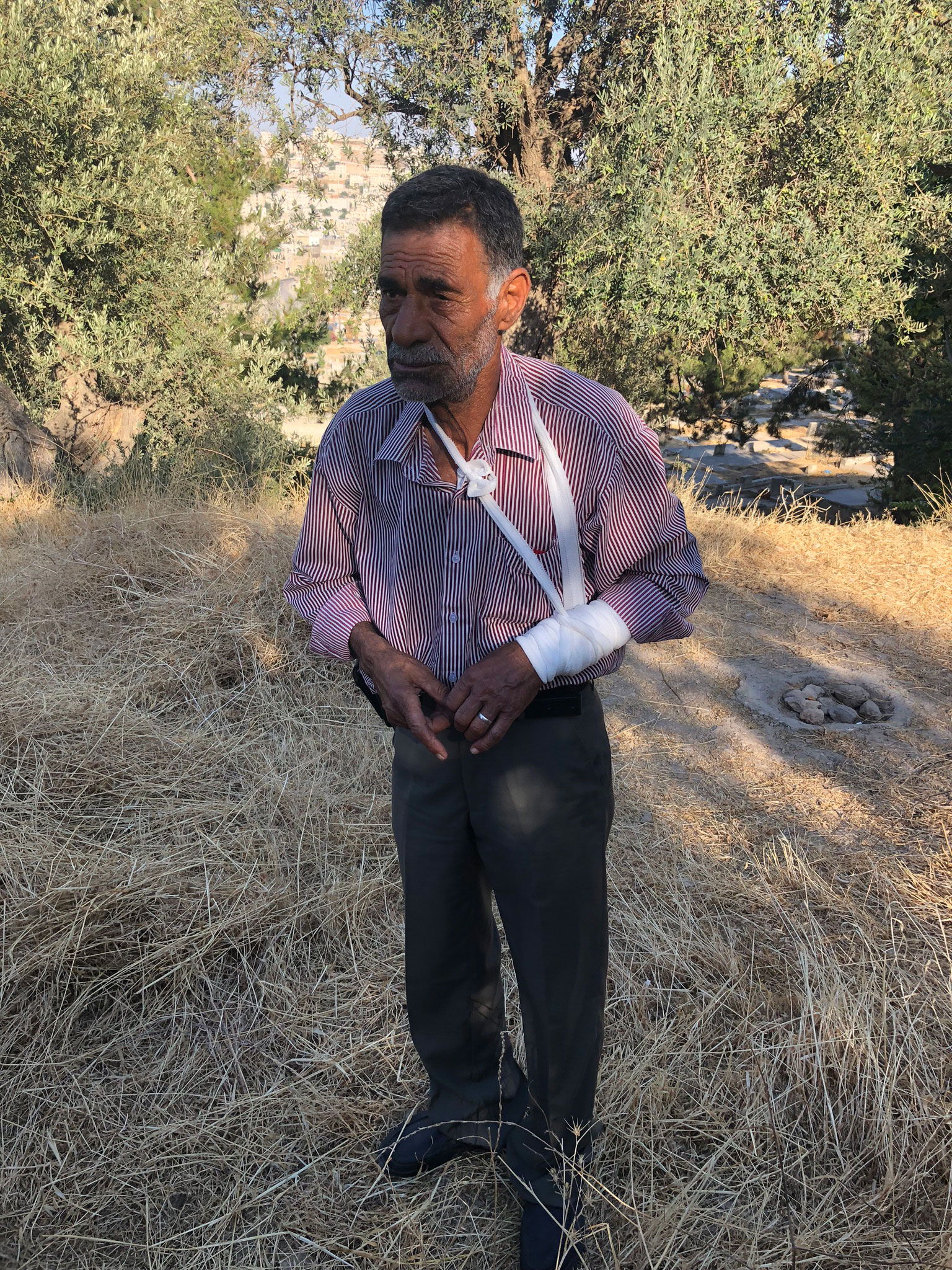 Idrees Zahdeh stands in his field where he was attacked.