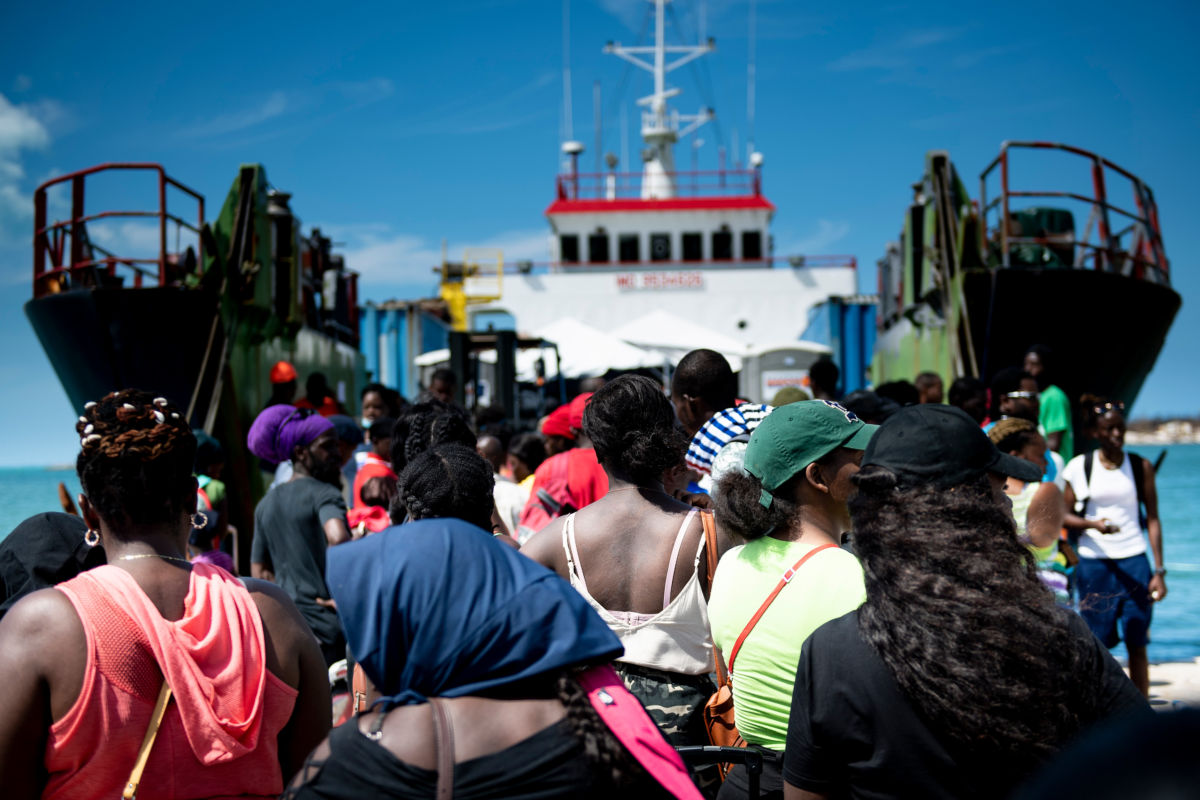 People line up to board a ferry