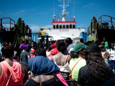 People line up to board a ferry