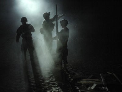 U.S. soldiers fortify an Afghan Highway Police checkpoint with razor wire in Robat, Afghanistan, March 19, 2010.