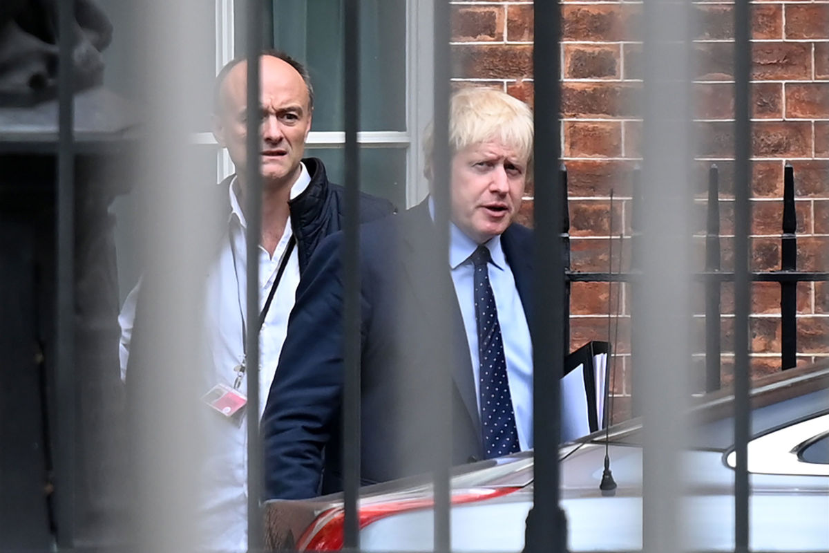 Britain's Prime Minister Boris Johnson and his special adviser Dominic Cummings leave from the rear of Downing Street in central London on September 3, 2019, before heading to the Houses of Parliament.