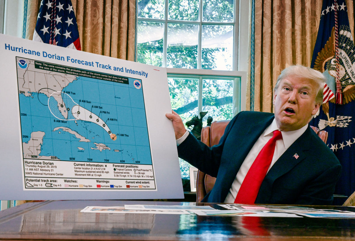 Donald Trump looks at a bogus map of hurricane dorian's forecast