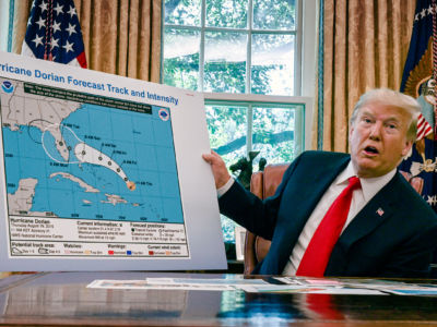 Donald Trump looks at a bogus map of hurricane dorian's forecast