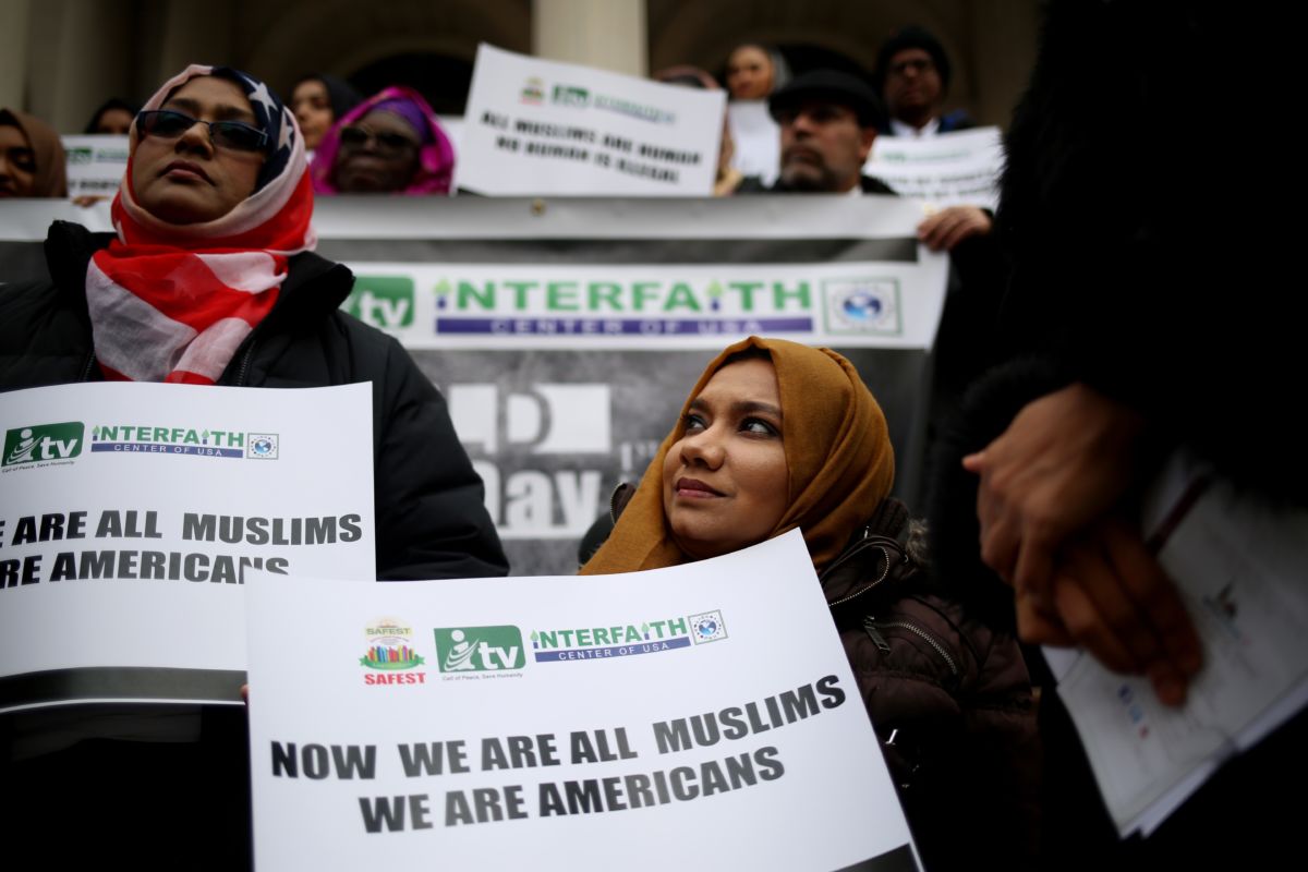 Hijabis display signs during a protest