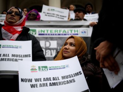 Hijabis display signs during a protest