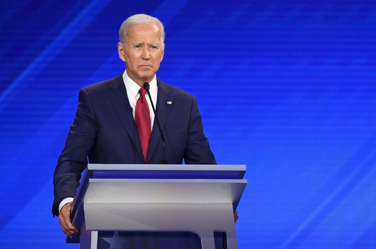 Joe Biden frowns while standing at a podium