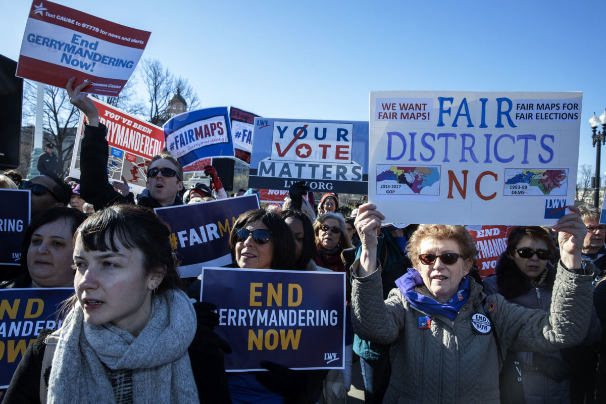 Protesters display signs opposing gerrymandering