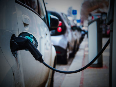 An electric car charges on the street