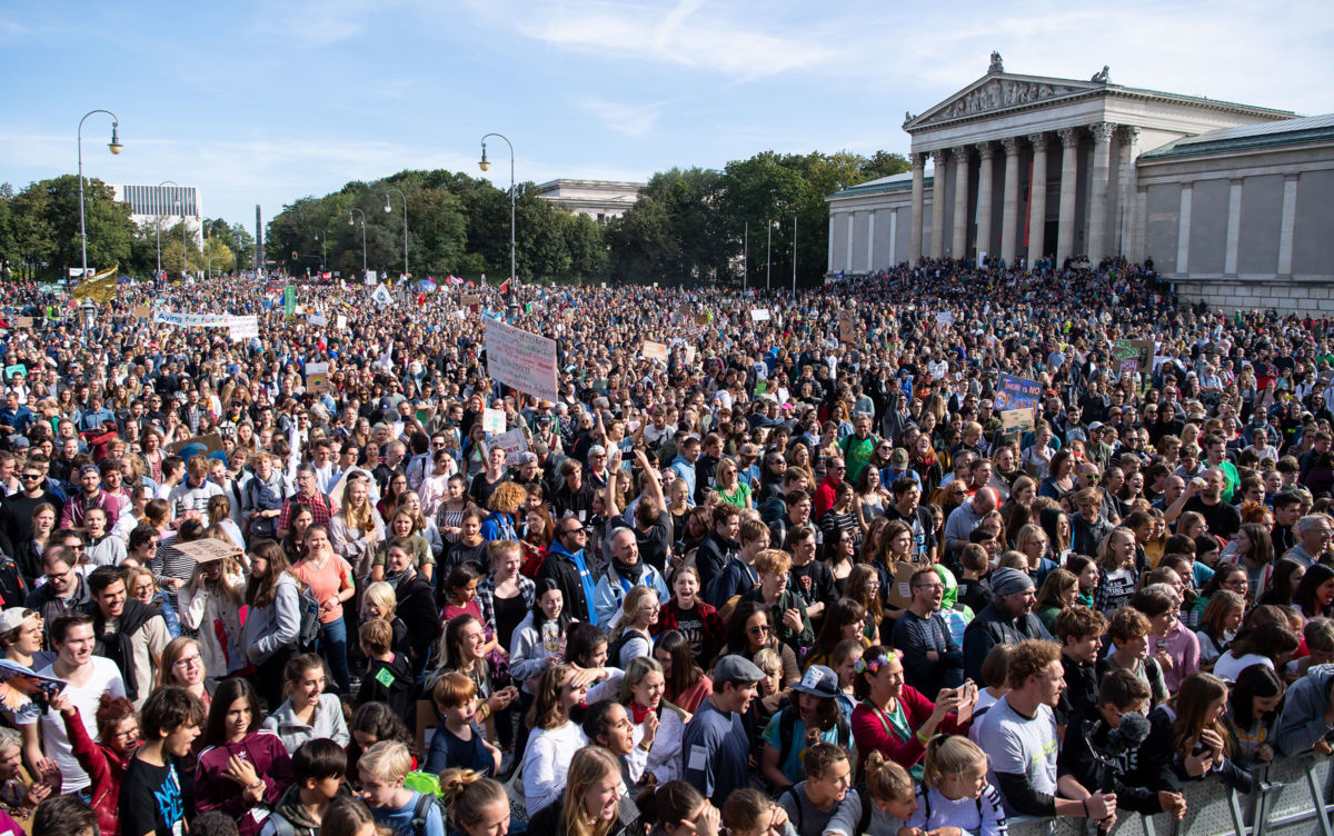 An expansive crowd of people protest inaction in the face of the the looming climate apocalypse