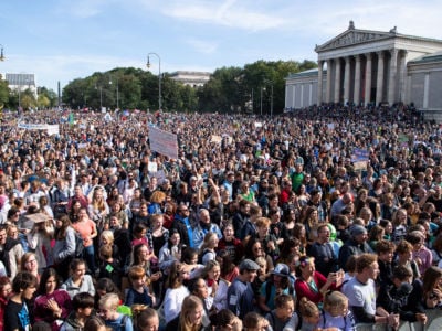 An expansive crowd of people protest inaction in the face of the the looming climate apocalypse