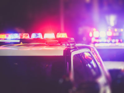 Blue and red lights flash on top of a police car