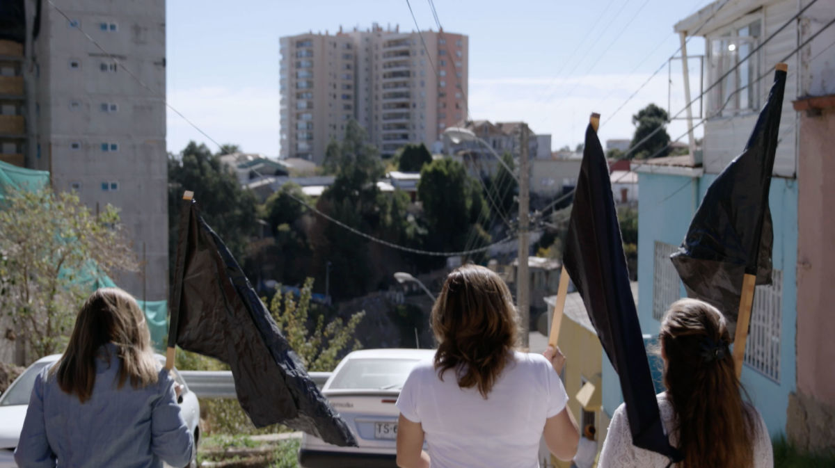 Housing activists carry black flags in Valparaíso, Chile.