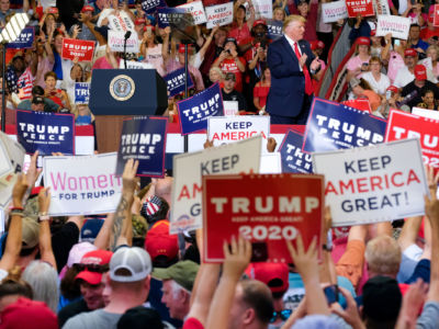 Donald Trump takes the stage during a rally