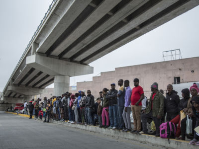 Numerous migrants from Central America queue up at a border crossing between Tijuana, Mexico, and the U.S.