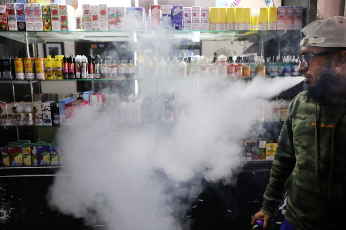 Andy Ramkumar, who works at Gotham Vape in Queens, vapes at the store on September 17, 2019 in New York City. Vaping, which many Americans have taken up as an alternative to smoking, has come under increased federal scrutiny following a rash of deaths related to vaping cannabis.