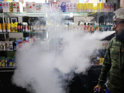 Andy Ramkumar, who works at Gotham Vape in Queens, vapes at the store on September 17, 2019 in New York City. Vaping, which many Americans have taken up as an alternative to smoking, has come under increased federal scrutiny following a rash of deaths related to vaping cannabis.