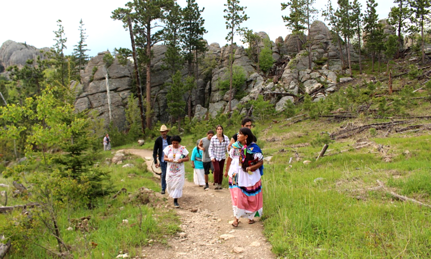 Cheryl Angel leads a group on pilgrimage at Black Elk Peak, one of four Lakota sacred sites that were visited during the Sovereign Sisters Gathering. 