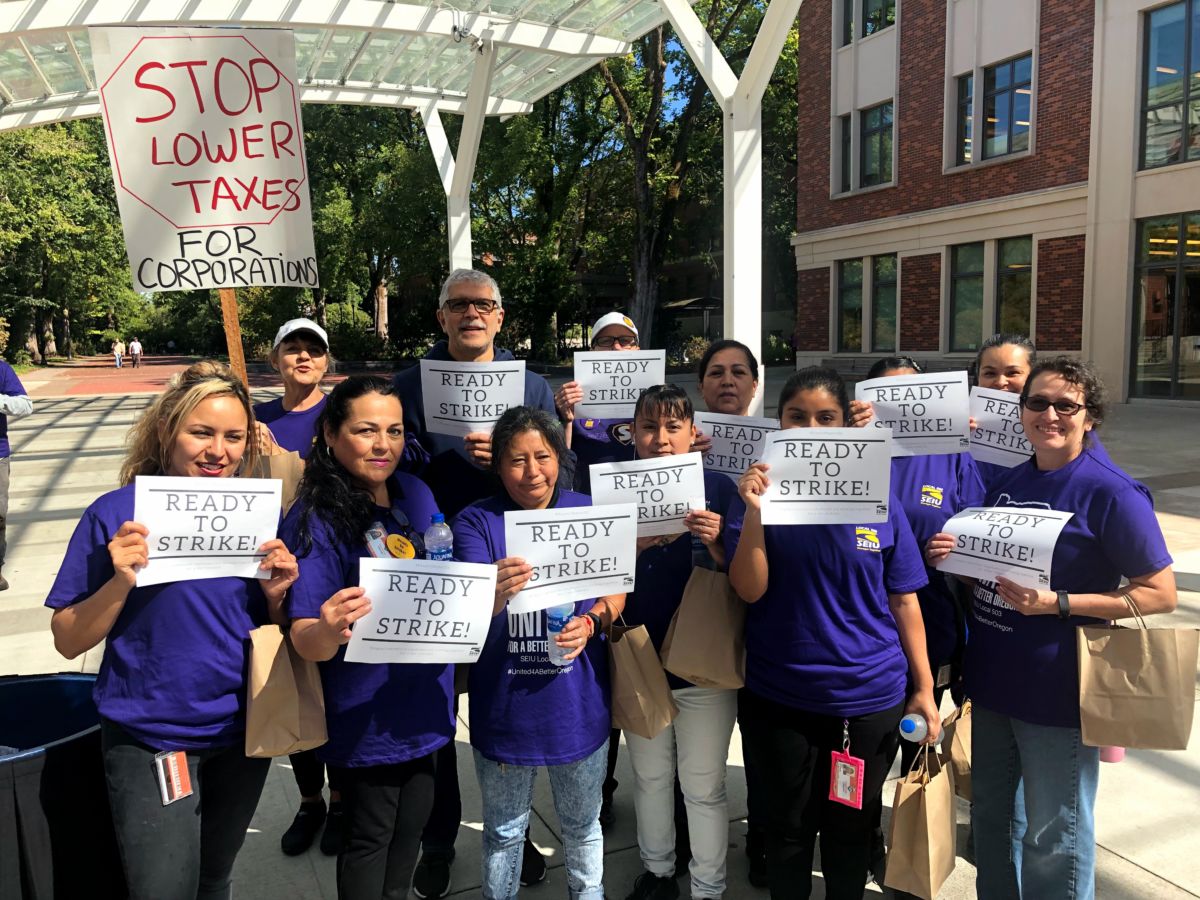 People in purple shirts display pro-union signs