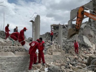 Rescue workers search for victims amongst the rubble of a building that was destroyed in an alleged Saudi-led airstrike targeting a Houthi-held detention center.