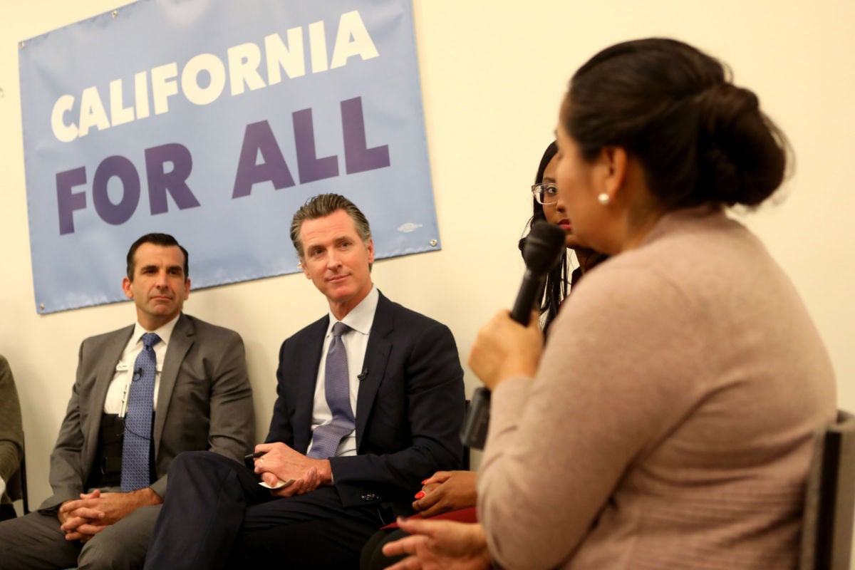 Governor Gavin Newsom, second from left, alongside San Jose Mayor Sam Liccardo, left, host a roundtable with local community members grappling with the state's housing crisis at the Seven Trees Community Center in San Jose, California, on January 15, 2019.