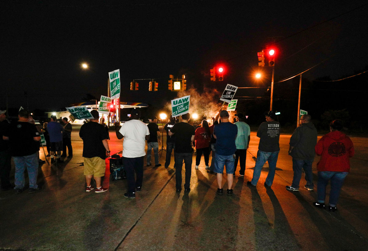 United Auto Workers (UAW) members picket at a gate at the General Motors Flint Assembly Plant