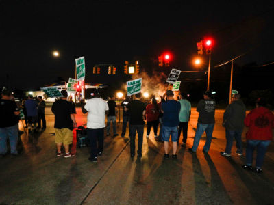 United Auto Workers (UAW) members picket at a gate at the General Motors Flint Assembly Plant