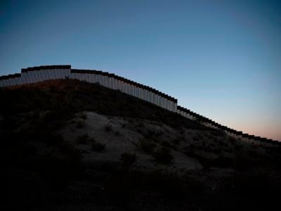 The border fence between the U.S and Mexico stretches across the horizon