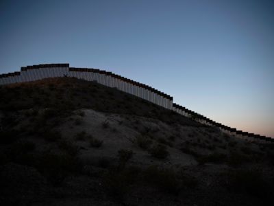 The border fence between the U.S and Mexico stretches across the horizon