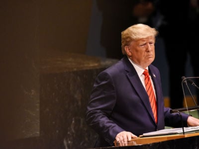 Donald Trump stands at a podium in the United Nations