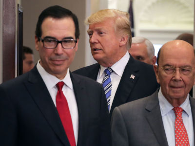 President Donald Trump arrives for a signing ceremony with Treasury Secretary Steven Mnuchin (L) and Commerce Secretary Wilbur Ross in the Roosevelt Room at the White House, March 8, 2018, in Washington, D.C.